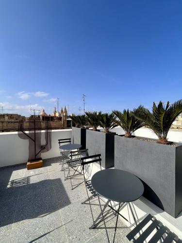 a row of tables and chairs on a patio at Kappuccini Hill boutique hotel - By Tritoni Hotels in Il-Furjana