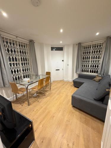 a living room with a couch and a table at Central London 2 bedroom apartment by the river thames in Victoria zone 1 in London