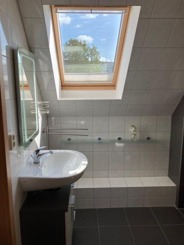 a bathroom with a sink and a window at Ferienwohnung 5 Anna in Bergen auf Rügen