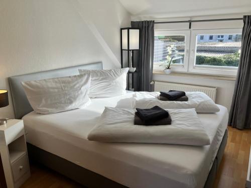 two white beds in a bedroom with a window at Ferienwohnung 5 Anna in Bergen auf Rügen