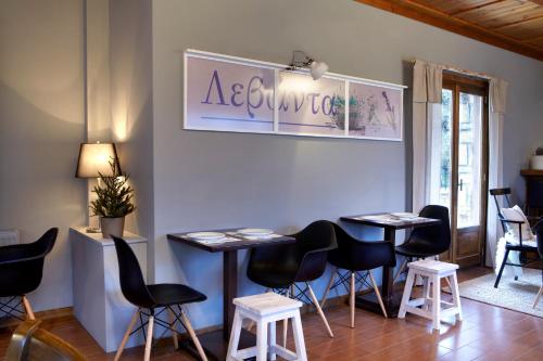a room with chairs and tables and a sign on the wall at Levanta in Méga Khoríon