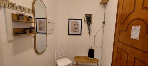 a hallway with a door and a chair and a stool at Diamond apartments in Artemida