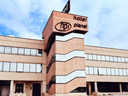 a building with a sign on top of it at Hotel Planet International in Arezzo
