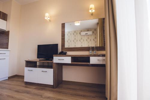 a room with a desk with a mirror and a computer at Avenue Deluxe Hotel in Sunny Beach