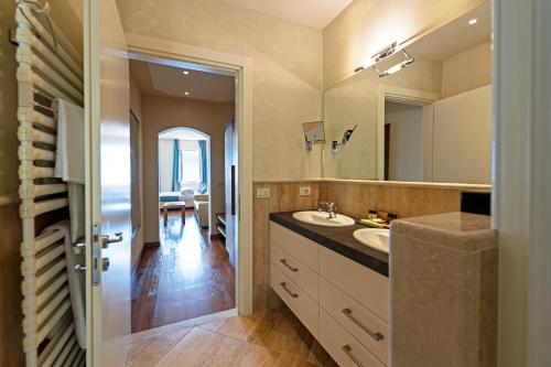 a bathroom with a sink and a mirror at Hotel Baia D'Oro - Adults Only in Gargnano