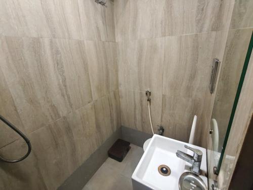 a bathroom with a shower and a white sink at Hotel Silver Shine Jogeshwari in Mumbai