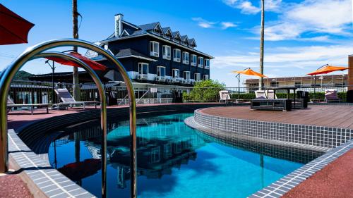 a swimming pool in front of a building at Alaise De Bale Shirahama in Shirahama
