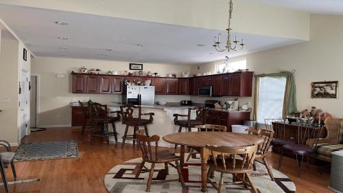 a kitchen and dining room with a table and chairs at Bayside Home With 4 Bedrooms And Elevator in North Beach Haven