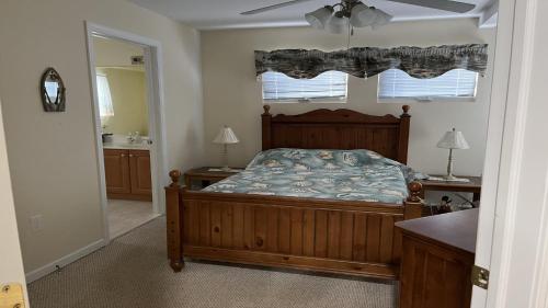 a bedroom with a bed and a sink and a mirror at Bayside Home With 4 Bedrooms And Elevator in North Beach Haven