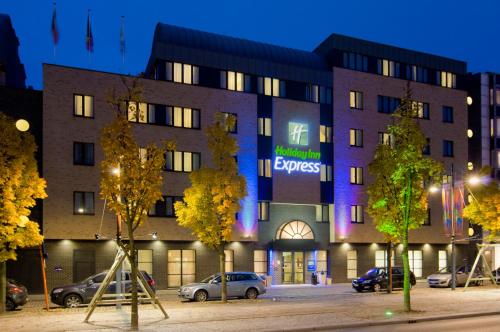 
a large building with a clock on the side of it at Holiday Inn Express Hasselt, an IHG Hotel in Hasselt
