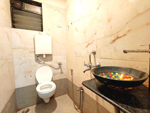 a bathroom with a sink and a toilet at Hotel Orange Inn in Koparpāda
