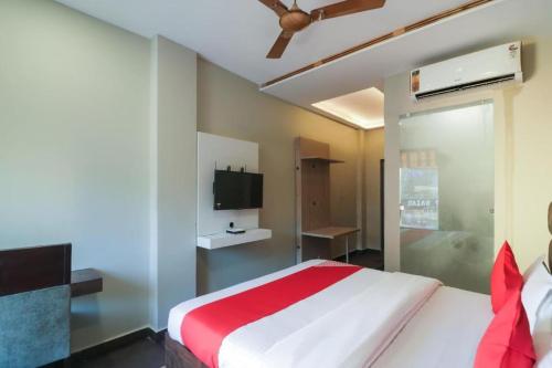 a bedroom with a large bed and a tv at Hotel MM Inn in Rishīkesh