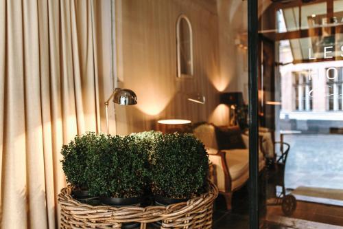 a basket with plants in it next to a room at Lesar Hotel Angel - Member of Hip Hotels in Ljubljana