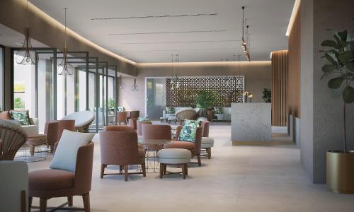 a lobby with chairs and tables in a building at Solimar Aquamarine Resort in Gerani Chanion