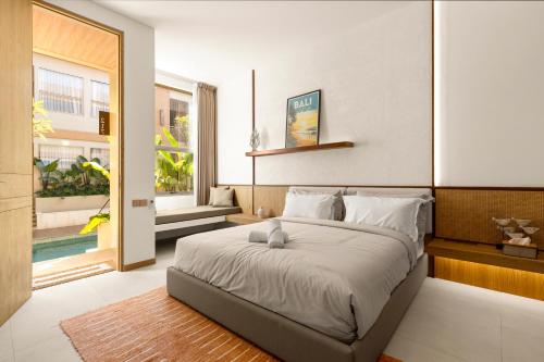 a bedroom with a large bed in a room at KAIA Canggu in Canggu