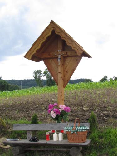 a picnic table with a umbrella on top of it at Urlaub am Lacknerhof - Familie Klocker in Liebenfels