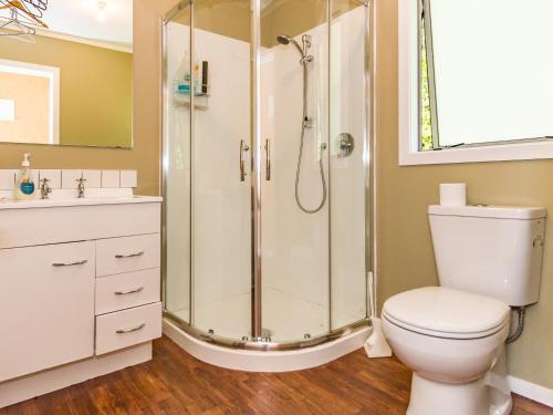 a bathroom with a shower and a toilet at Sweet Rangataua - Rangataua Bach in Ohakune