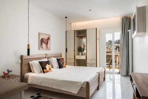 a bedroom with a bed with a teddy bear on it at Ipsos Pool Apartments, Elena & Maria by Konnect in Ipsos