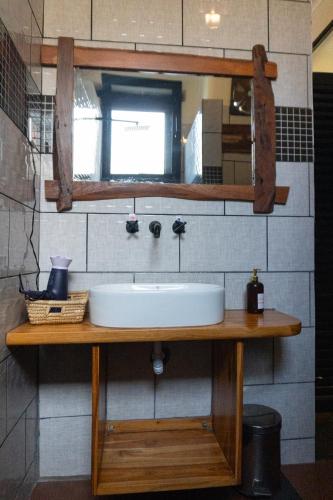 a bathroom with a sink and a mirror at The Maridadi Hotel in Moshi