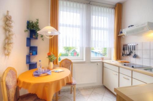 a kitchen with a table with a yellow table cloth on it at Haus Sonnenruh in Oberhof