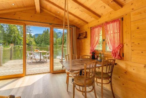 a dining room with a table and chairs in a cabin at Tiny Water Villa on a Lake with shared camping bathroom in Zweisimmen