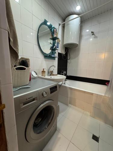 a bathroom with a washing machine and a sink at Apartment old Batumi in Batumi