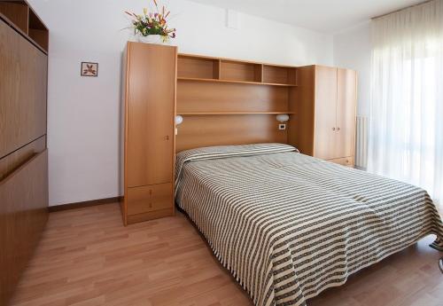 Ένα ή περισσότερα κρεβάτια σε δωμάτιο στο Casavacanze Internazionale