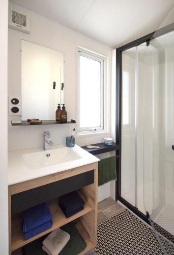 a bathroom with a sink and a shower at CAMPING PARADIS Domaine Oyat in Le Fenouiller