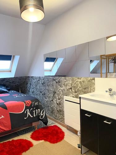 a bedroom with a bed and a sink and a mirror at Près de l aéroport Orly Parking gratuit in Villeneuve-le-Roi