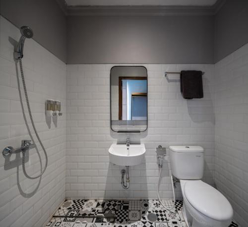 a bathroom with a toilet and a sink at THE FOLK in Yogyakarta