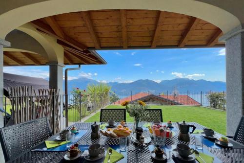 a table with food on it on a patio at Villa Aurelia in Plesio