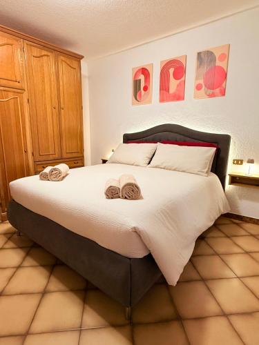 a bedroom with a large bed with two towels on it at Incentro in Grosio