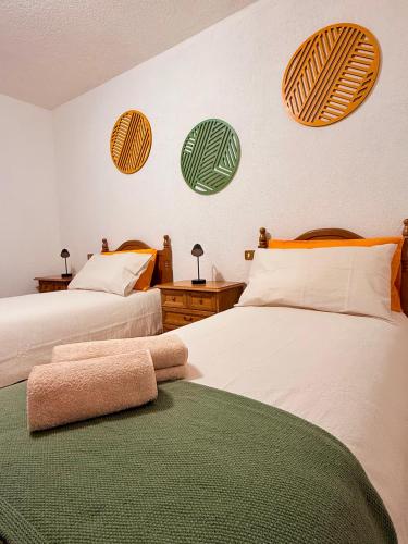 a bedroom with two beds with a towel on the floor at Incentro in Grosio