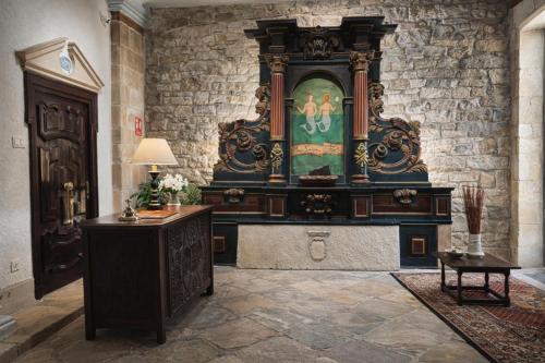 a large altar in a room with a stone wall at Palacio Pampinot in Hondarribia