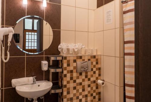 a bathroom with a sink and a mirror at Central Hotel 21 in Budapest