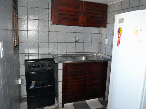 a kitchen with a sink and a stove at Hotel Enseada de Ponta Negra in Natal