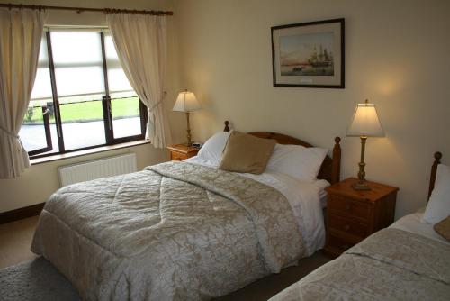 1 dormitorio con 2 camas y ventana en Dunaree Bed and Breakfast, en Bunratty