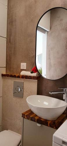 a bathroom with a white sink and a mirror at Studio port santa lucia in Saint-Raphaël