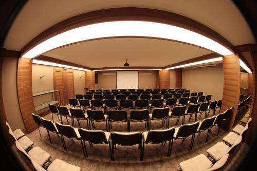 an auditorium with rows of chairs in a room at Grand Hotel Gaziantep in Gaziantep