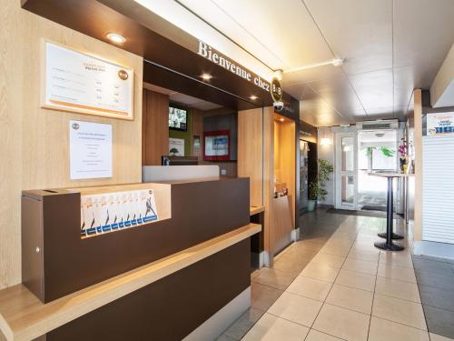 a lobby of a dental office with a reception desk at B&B HOTEL Herblay in Herblay
