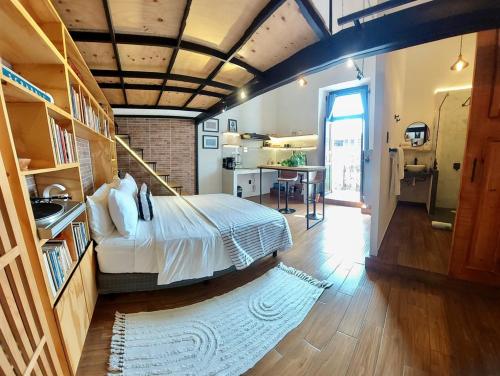 a bedroom with a large bed and a kitchen at Hotel Casa Ibarra in Acámbaro