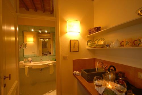 a bathroom with a sink and a mirror and a sink at Pieve di Caminino Historic Farm in Podere Caminino