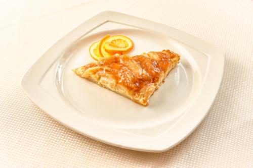 a white plate with a piece of food on it at Hotel Mrak in Ljubljana