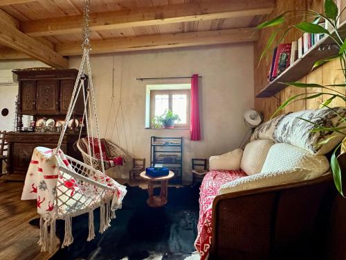 a living room with a swing in a room at La Ferme de Tart in Verdonnet