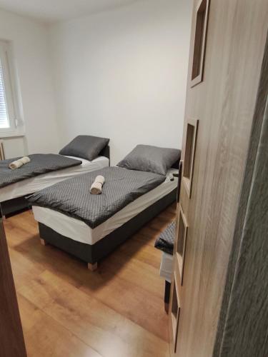 a bedroom with two beds in a room at Central Apartman Tatabánya in Tatabánya
