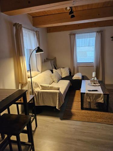 a living room with a bed and a table at Chalupa uprostred niceho in Hlinsko