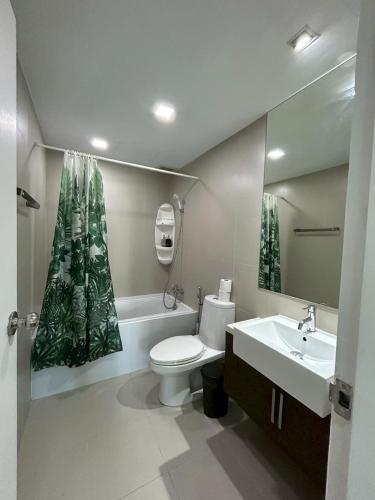 a bathroom with a toilet and a sink and a mirror at Luxury Condo Skywalk BTS Thonglor Pool Gym and Netflix in Bangkok