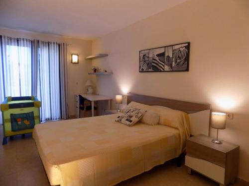 a bedroom with a bed and a table and a television at Casa Jazmin in Cala Bona