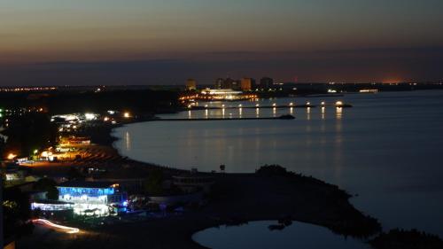 a view of a harbor at night with lights on the water at Hotel Capitol in Jupiter