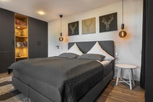 a bedroom with a large bed and a table at Place 4you in Grafenau
